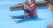 Landon joined the competition — help win amazing prizes! adult, baby, child, family, holding, mother, outdoor, parent, park, playful, pool, portrait, rocks, sitting, smiling, splash, summer, swimming, water, waterfall
