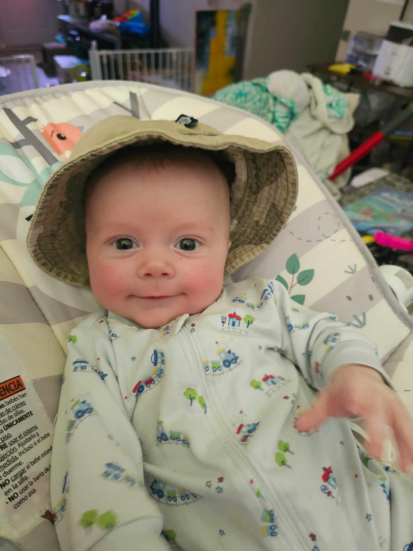 Ethan is registered to the contest to win money with this photo: baby, child, hat, onesie, smile, face, infant, cushion, seat, clothing, indoor, hand, pattern, toy, furniture, person, cute, expression, relaxing, baby_seat