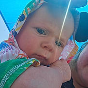 Ethan is registered to the contest to win money with this photo: baby, child, face, hood, colorful_clothing, sunlight, lens_flare, blue_sky, outdoor, person, closeup, arm, expression, infant, cute, skin, headwear, portrait, people, daylight