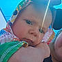 arm, baby, blue_sky, child, closeup, colorful_clothing, cute, daylight, expression, face, headwear, hood, infant, lens_flare, outdoor, people, person, portrait, skin, sunlight