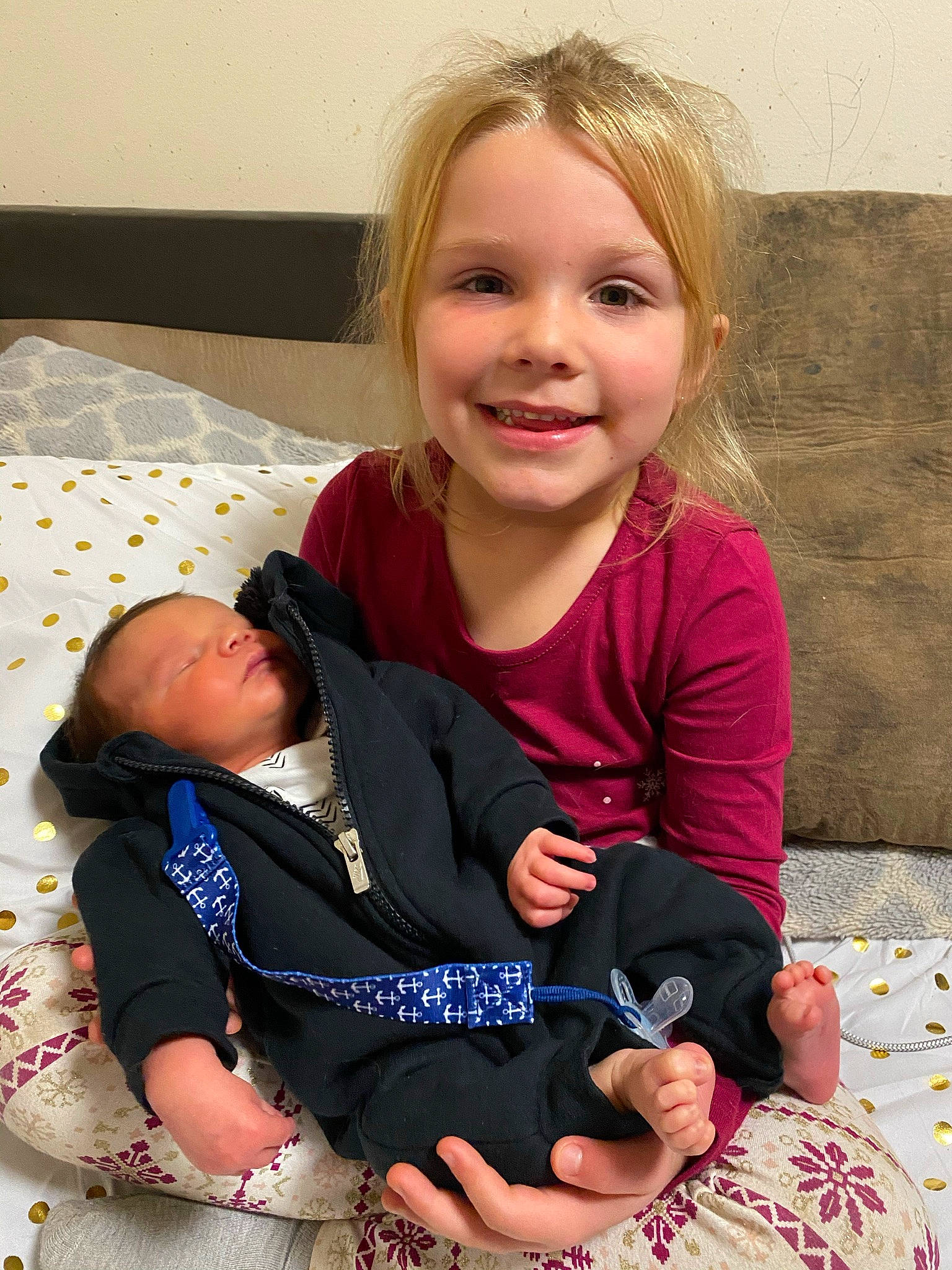 Bridgette is registered to the contest to win money with this photo: child, finger, happy, joy, lap, person, sibling, sitting, smile, toddler