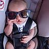 Jasper joined the competition — help win amazing prizes! baby, child, sunglasses, car_seat, seatbelt, infant, person, cute, fashion, accessory, clothing, hand, face, head, seat, safety, young, cool, portrait, indoor
