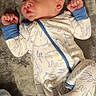 Jasper is registered to the contest to win money with this photo: baby, infant, onesie, elephant_pattern, blanket, fist, curious, lying_down, sleepwear, soft_texture, cute, newborn, person, indoors, cozy, child, head, face, blue_cuffs, resting