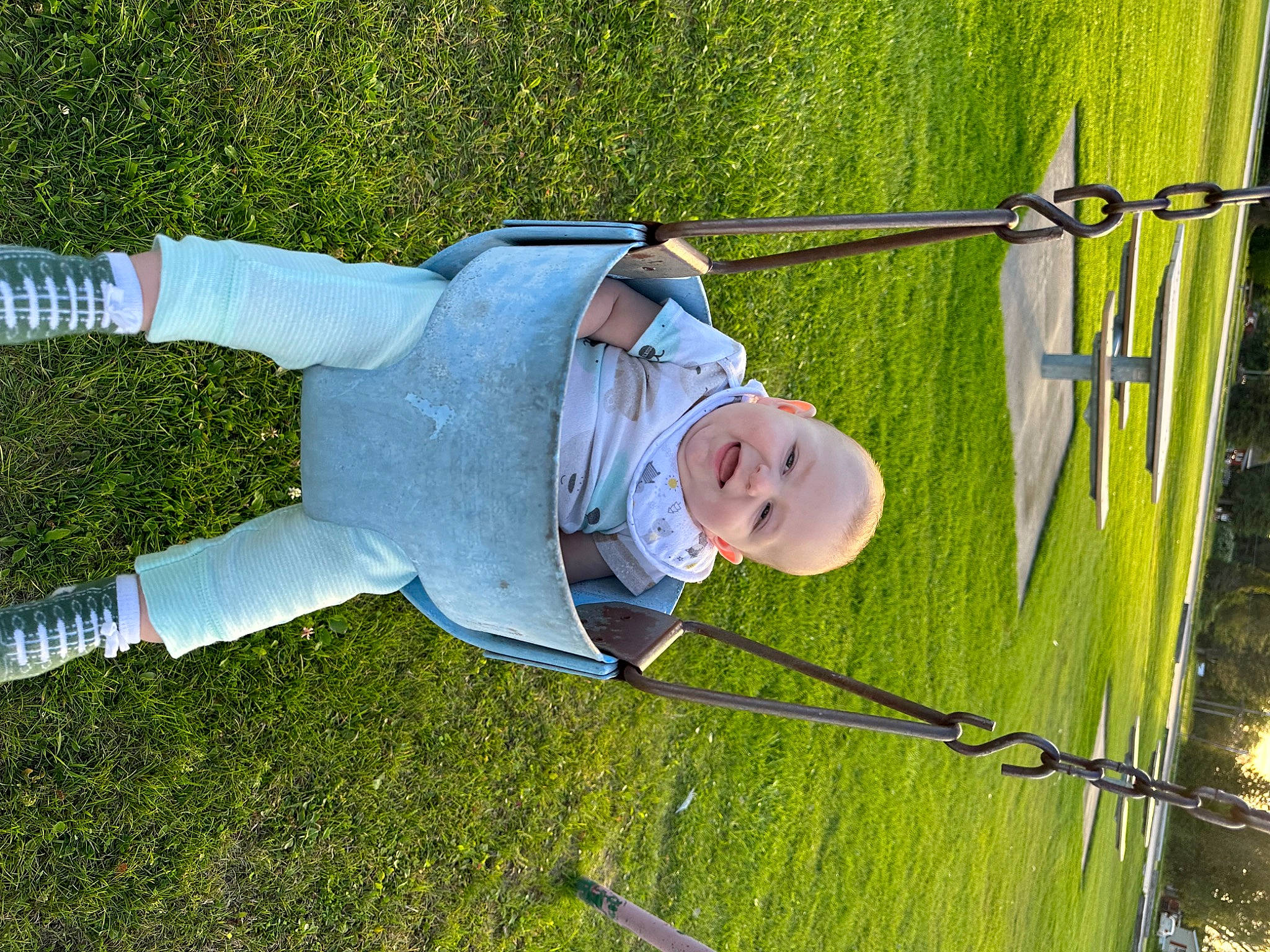Karson is registered to the contest to win money with this photo: baby, child, event, fun, grass, grass_family, grassland, happy, hat, joy, landscape, leisure, outdoor_play_equipment, people_in_nature, person, plant, playground, recreation, swing, toddler