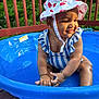 Leilani is registered to the contest to win money with this photo: baby, blue_pool, bracelet, child, cute, deck, happy, outdoor, playful, pool, smiling, strawberry_pattern, striped_clothing, summer, sun_hat, sunlight, swimsuit, toddler, water, wooden_deck