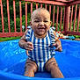 baby, blue_pool, child, cute, deck, fun, greenery, happy, infant, outdoor, play, portrait, sitting, smiling, striped_clothing, summer, sunny_day, swimsuit, water, wooden_railings