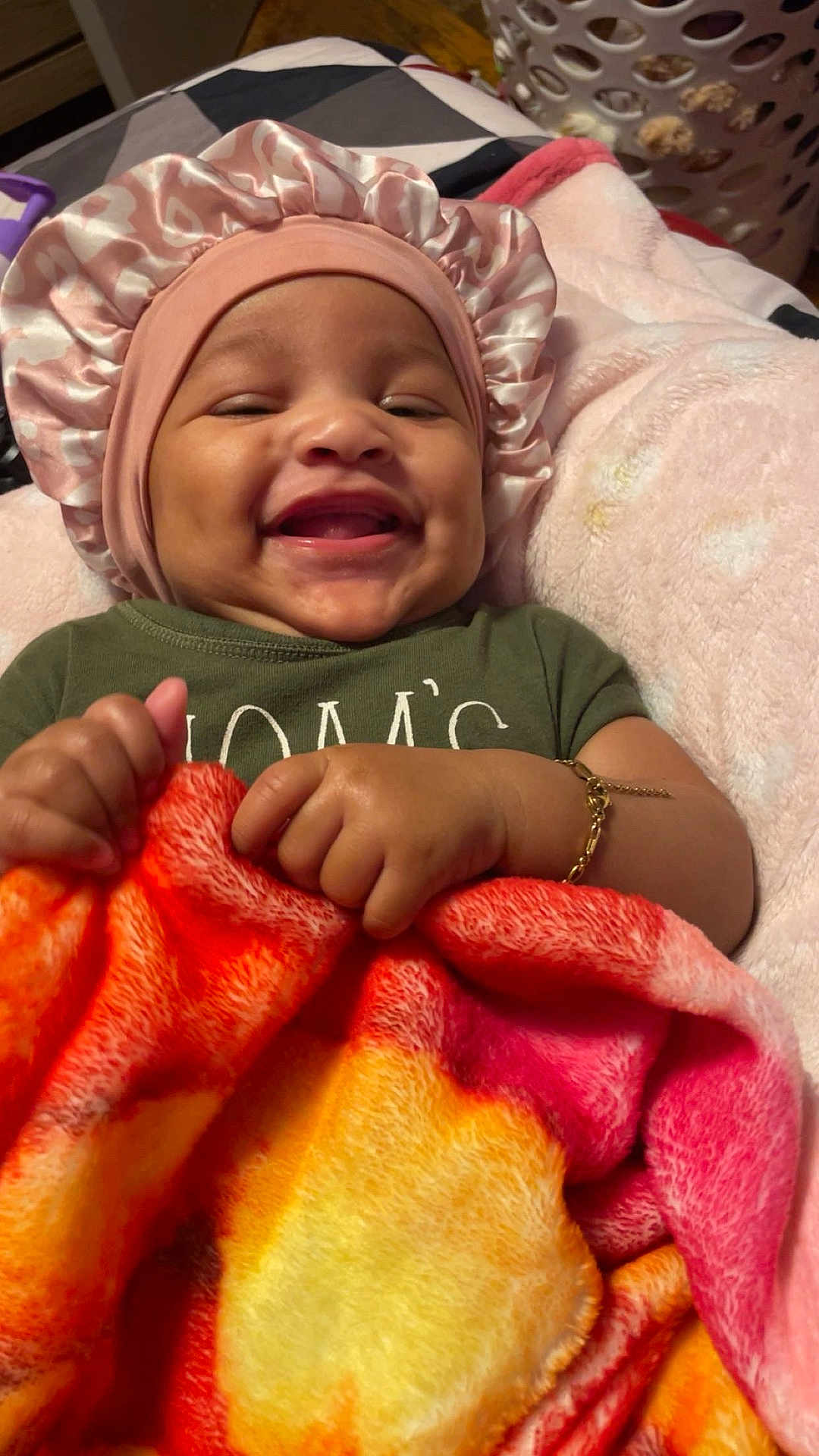 Leilani joined the competition — help win amazing prizes! baby, blanket, bonnet, bracelet, child, clothing, colorful, cozy, cute, fabric, face, hand, happy, indoors, infant, jewelry, person, portrait, smiling, soft