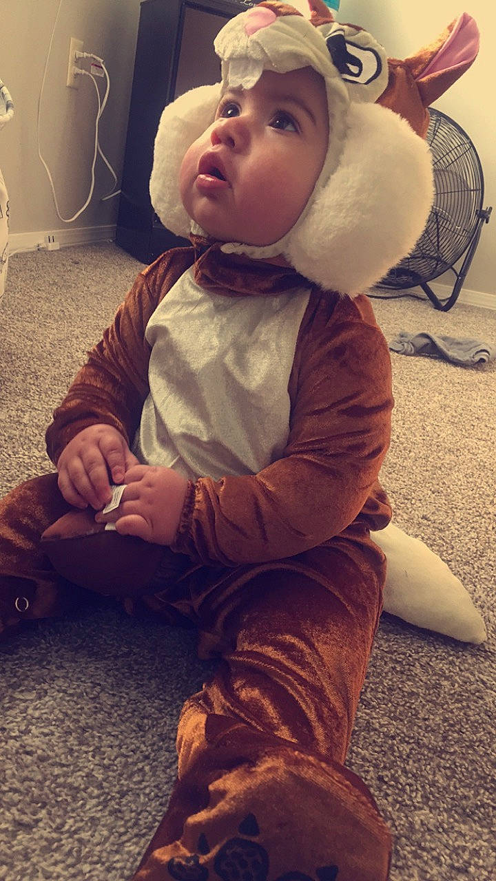 Nickolas is registered to the contest to win money with this photo: cheek, child, cool, ear, fur, head, headgear, headwear, outerwear, person, sitting, toddler