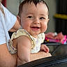 baby, child, smile, face, person, infant, happy, skin, hair, arm, clothing, sleeveless, adult, holding, indoor, blurred_background, closeup, portrait, cute, expression