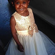 Aundrianna is registered to the contest to win money with this photo: child, girl, smiling, portrait, dress, formalwear, sparkly_dress, white_dress, gold, bow, car, vehicle, outdoor, standing, curly_hair, dark_skin, happy, fashion, photography, celebration