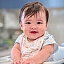 baby, infant, smile, bib, highchair, hands, eyes, hair, face, portrait, closeup, cute, indoor, kitchen, background_blur, shallow_depth_of_field, feeding_time, chubby_cheeks, sitting, happy