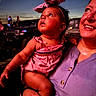 Eliza joined the competition — help win amazing prizes! baby, bow, car, child, clothing, curious, evening, face, family, headband, holding, outdoor, people, person, portrait, purple_shirt, smile, vehicle, warm_lighting, woman