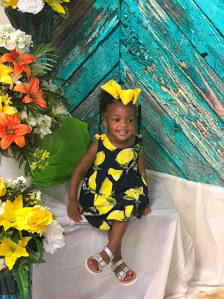Sanyah is registered to the contest to win money with this photo: child, costume, flower, fun, happy, joy, person, plant, smile, toddler, vacation, yellow