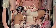 Kaylee joined the competition — help win amazing prizes! baby, sleeping, infant, baby_swing, pink, floral_pattern, socks, indoor, child, cute, resting, soft_toys, comfort, seat, peaceful, young_child, portrait, clothing, cushion, relaxation