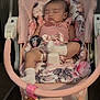 baby, sleeping, infant, baby_swing, pink, floral_pattern, socks, indoor, child, cute, resting, soft_toys, comfort, seat, peaceful, young_child, portrait, clothing, cushion, relaxation