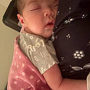 Kaylee is registered to the contest to win money with this photo: baby, sleeping, blanket, polka_dot, arm, shirt, floral_pattern, close_up, nap, peaceful, infant, child, soft_lighting, indoor, portrait, cuddle, pink, gray, fabric, human