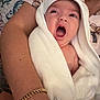 Kaylee joined the competition — help win amazing prizes! baby, towel, yawning, person, arm, bracelet, patterned_clothing, bed, pillow, wooden_headboard, indoor, closeup, smile, wrapped, holding, skin, adult, comfort, relaxation, blanket