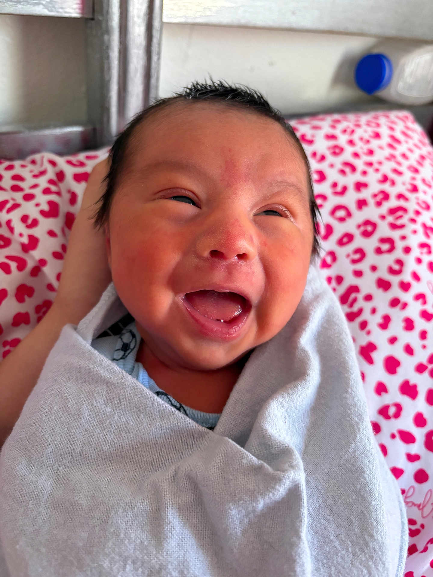 Ismael is registered to the contest to win money with this photo: baby, newborn, smiling, blanket, bed, pillow, face, happy, infant, head, person, wrapped, indoor, skin, mouth, hair, clothing, cute, expression, lying