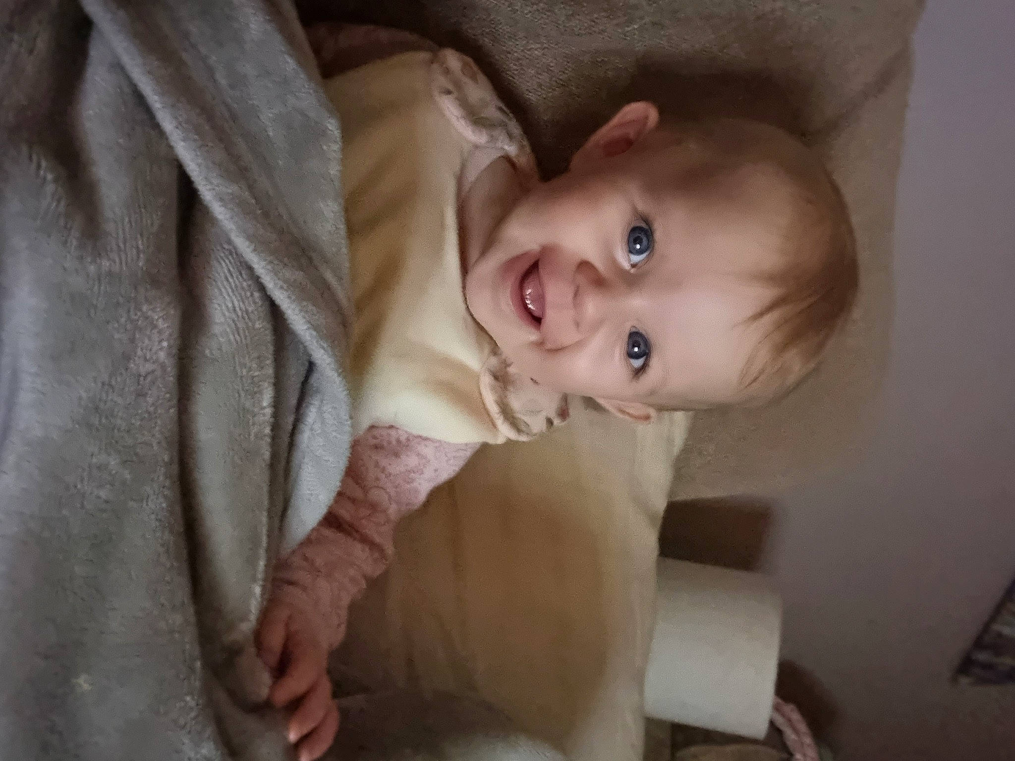 Amelia is registered to the contest to win money with this photo: baby, baby_products, baby_toddler_clothing, cheek, child, comfort, dress, flash_photography, fun, happy, iris, laugh, lip, nose, person, sitting, skin, sleeve, smile, toddler