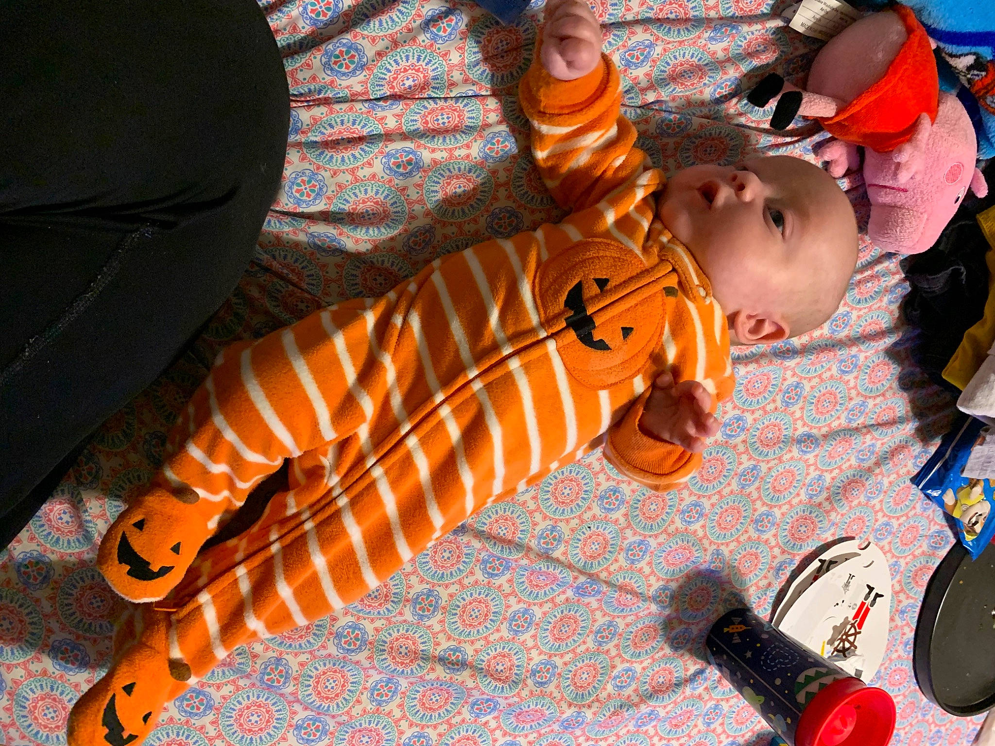 Ethan is registered to the contest to win money with this photo: audio_equipment, baby, baseball_cap, child, flooring, fun, hat, musical_instrument, orange, pattern, person, play, room, sitting, smile, toddler, toy