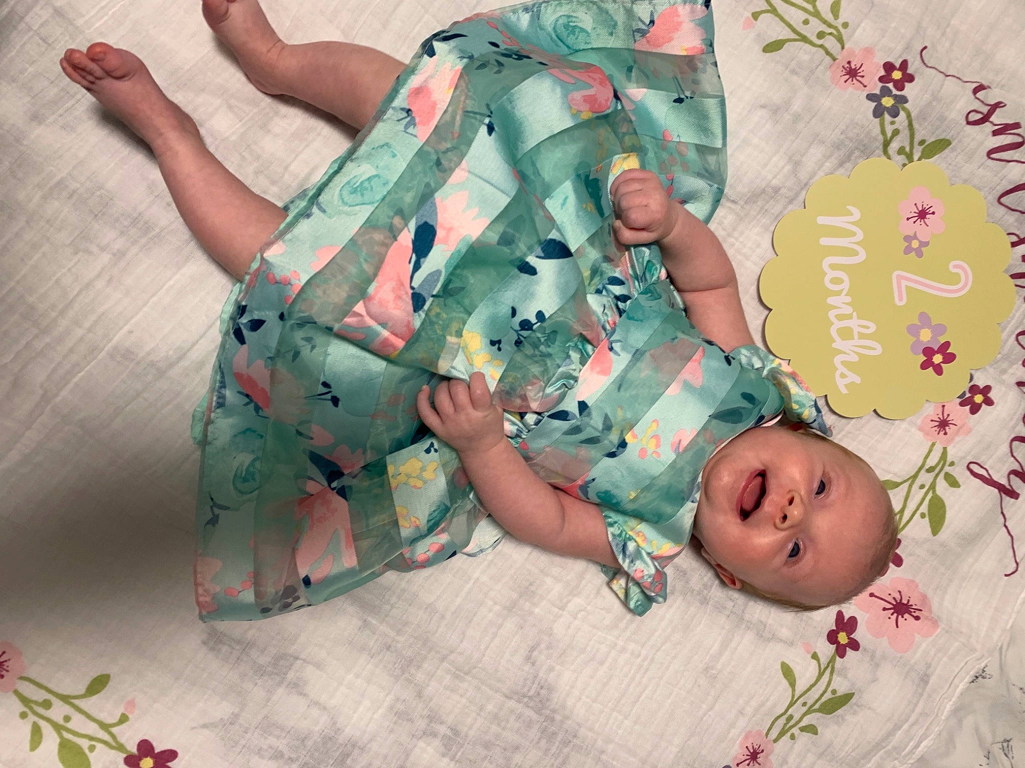 Holly is registered to the contest to win money with this photo: baby, baby_products, baby_toddler_clothing, camouflage, child, comfort, face, happy, head, human_body, knee, leg, linens, military_camouflage, pattern, person, pink, room, sleeve, thigh