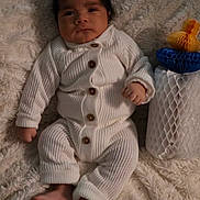 Gian joined the competition — help win amazing prizes! baby, infant, white_clothing, knitwear, blanket, fluffy_texture, face, expression, hand, foot, lying_down, indoor, decor, colorful, orange, blue, white, buttoned_outfit, soft, cute