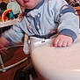 Zachariah is registered to the contest to win money with this photo: baby, child, high_chair, blue_onesie, face, hand, toy, living_room, carpet, dog, furniture, person, infant, expression, indoor, footwear, play, couch, colorful, curious