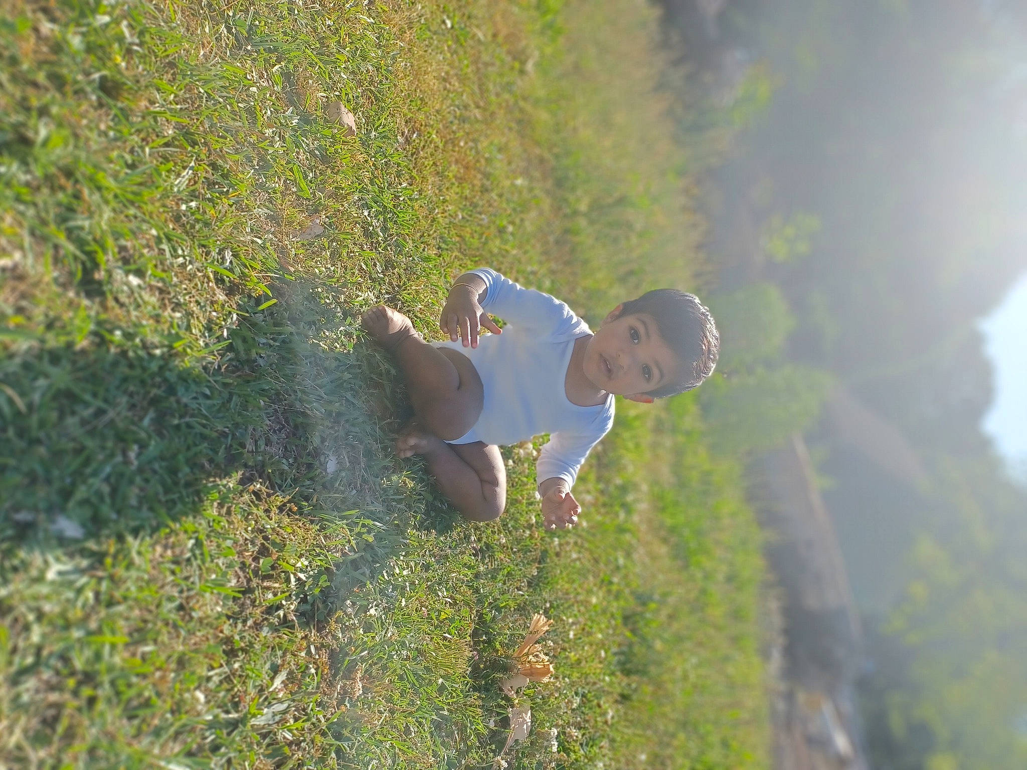 Krish joined the competition — help win amazing prizes! ecoregion, fun, grass, grass_family, grassland, happy, hill, landscape, leisure, meadow, natural_environment, people_in_nature, person, plant, plant_community, shrub, sky, sunlight, toddler, vegetation