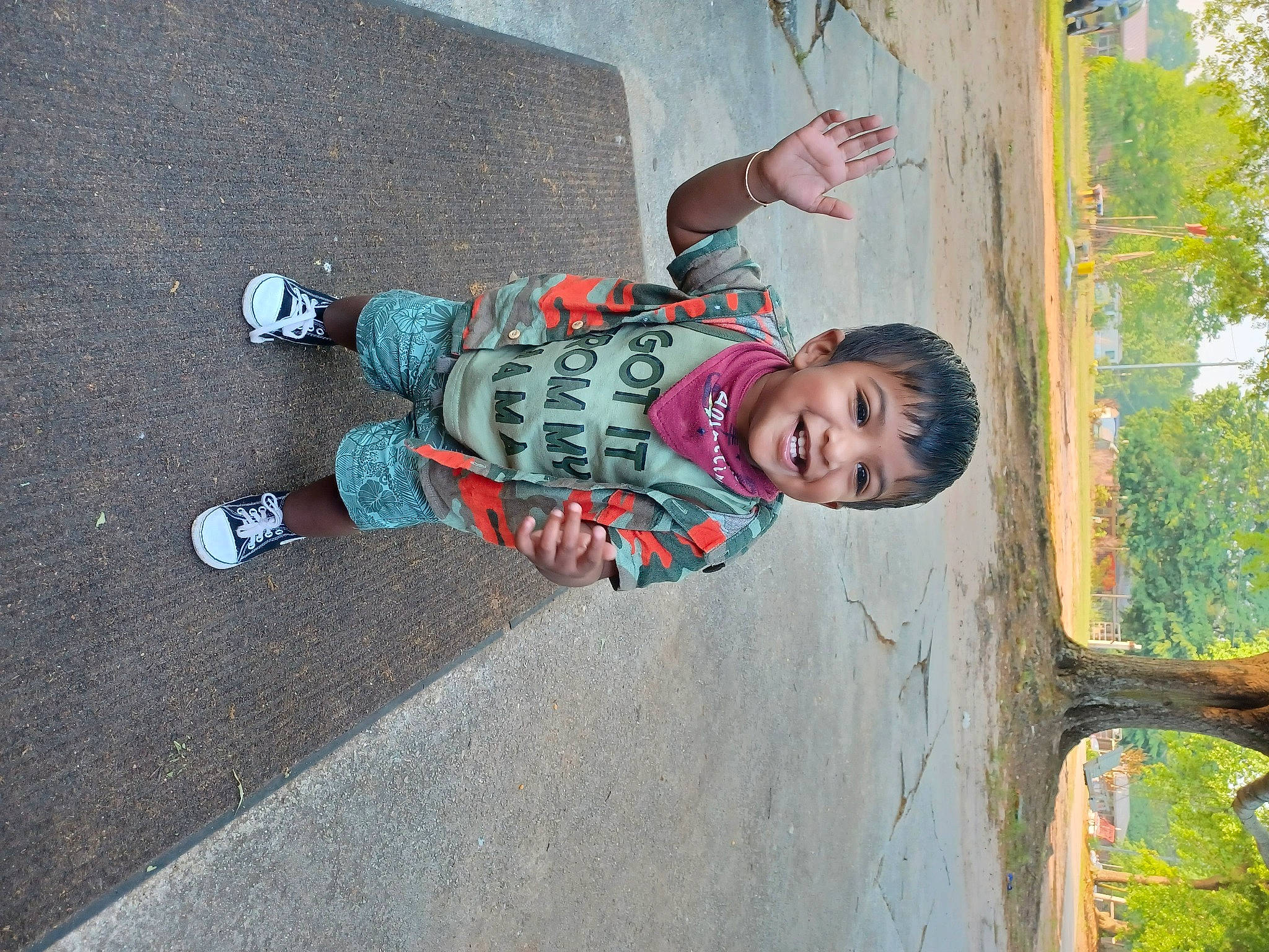 Krish joined the competition — help win amazing prizes! asphalt, child, concrete, fun, happy, human_leg, joy, leisure, outdoor_shoe, pattern, person, recreation, road_surface, shadow, sidewalk, smile, toddler, tree, trunk, walking_shoe