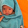 Elya participe au concours pour gagner de l'argent avec cette photo : baby, towel, blue_towel, infant, wrapped, face, eyes, hand, orange_background, soft_texture, newborn, cute, portrait, skin, blanket, cozy, warm, person, indoors, closeup
