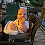 Oliver joined the competition — help win amazing prizes! baby, high_chair, food, outdoor, deck, wooden_floor, chair, table, greenery, evening, person, infant, cute, smiling, feeding, backyard, relaxing, summer, family, portrait