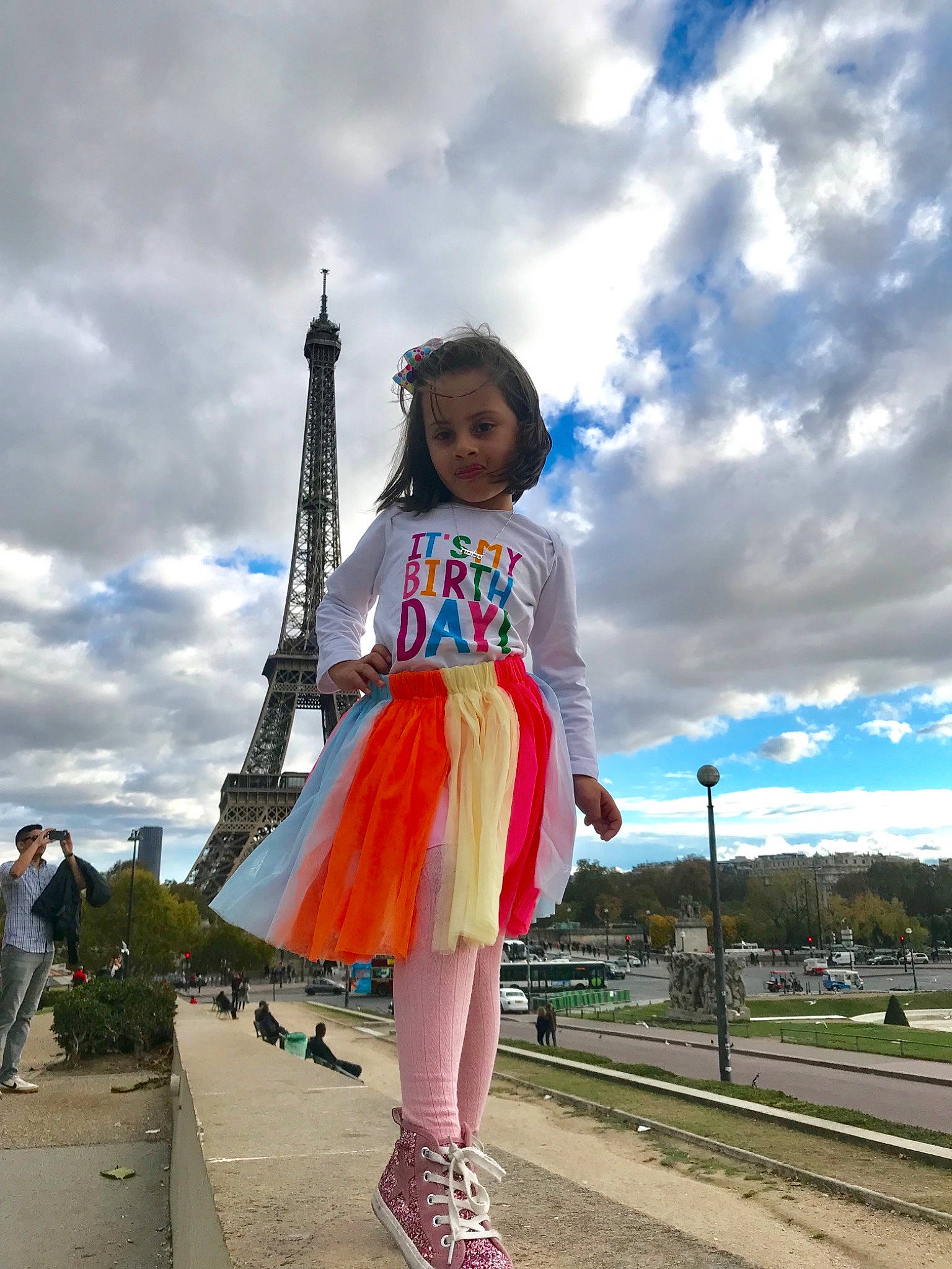 Salome is registered to the contest to win money with this photo: asphalt, cloud, electric_blue, event, fashion_design, fun, happy, human_leg, leisure, magenta, person, plant, pole, recreation, road, sandal, sky, street_fashion, toddler, travel