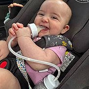 Kienna joined the competition — help win amazing prizes! baby, car_seat, feeding_bottle, feeding_tube, smile, infant, child, pink_clothing, polka_dot_strap, graco_brand, car_interior, happy, cute, holding, sitting, close_up, head, arm, face, baby_toy