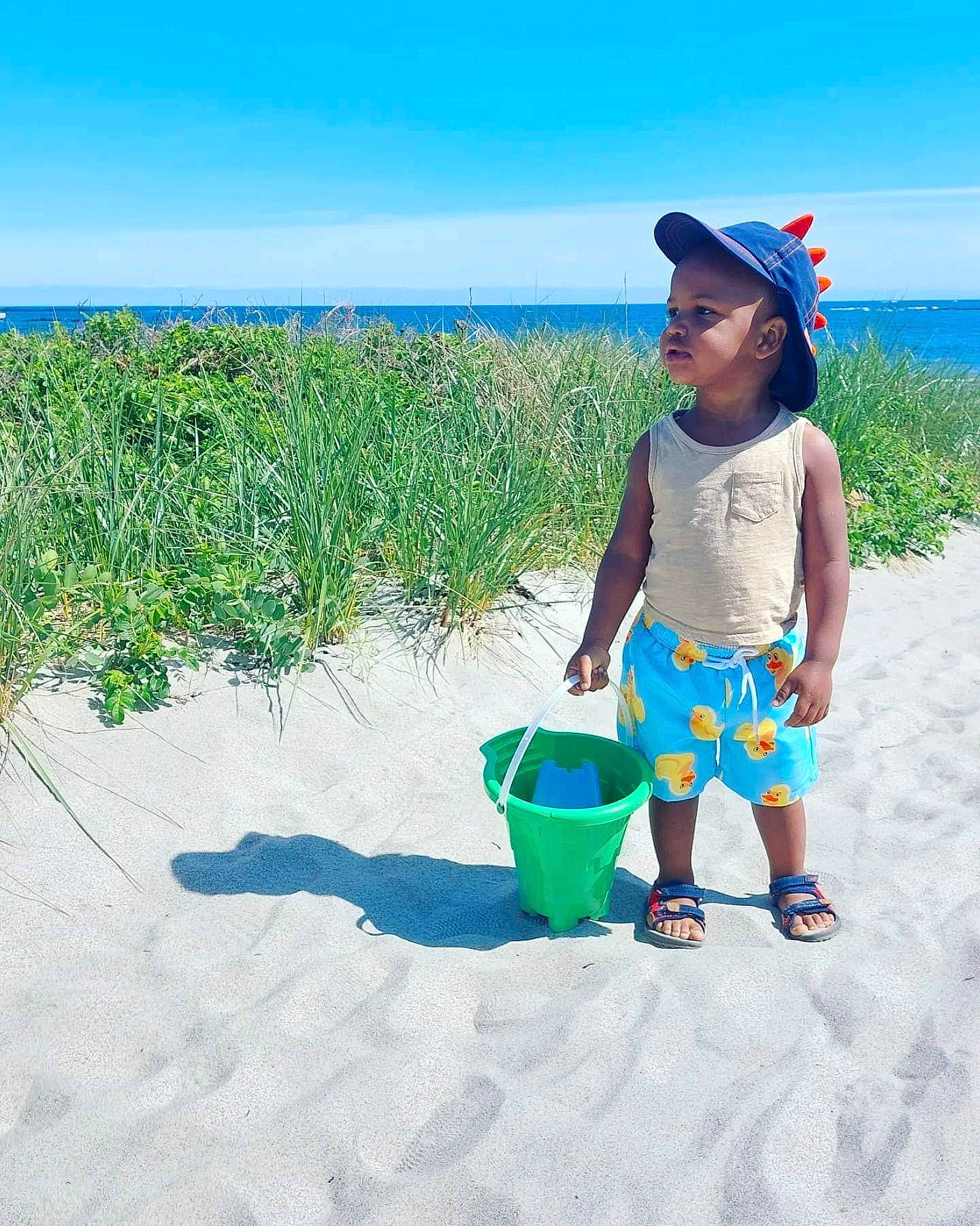 Princeton joined the competition — help win amazing prizes! azure, baby_toddler_clothing, beach, bucket, cap, electric_blue, grass, happy, hat, holiday, landscape, leisure, people_in_nature, person, plant, sand, sky, sun_hat, toddler, travel