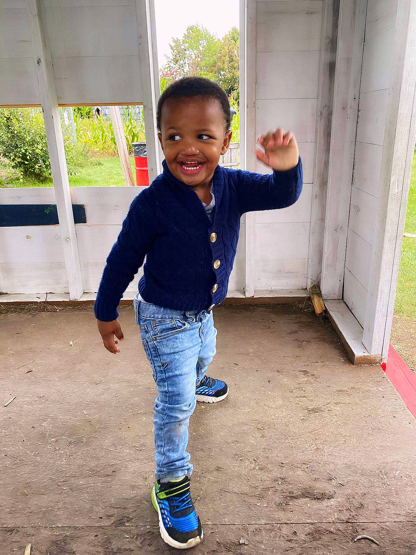 Princeton is registered to the contest to win money with this photo: baby_toddler_clothing, child, denim, electric_blue, fun, gesture, grass, happy, jeans, joy, leisure, pattern, people_in_nature, person, play, sitting, sleeve, smile, t_shirt, toddler