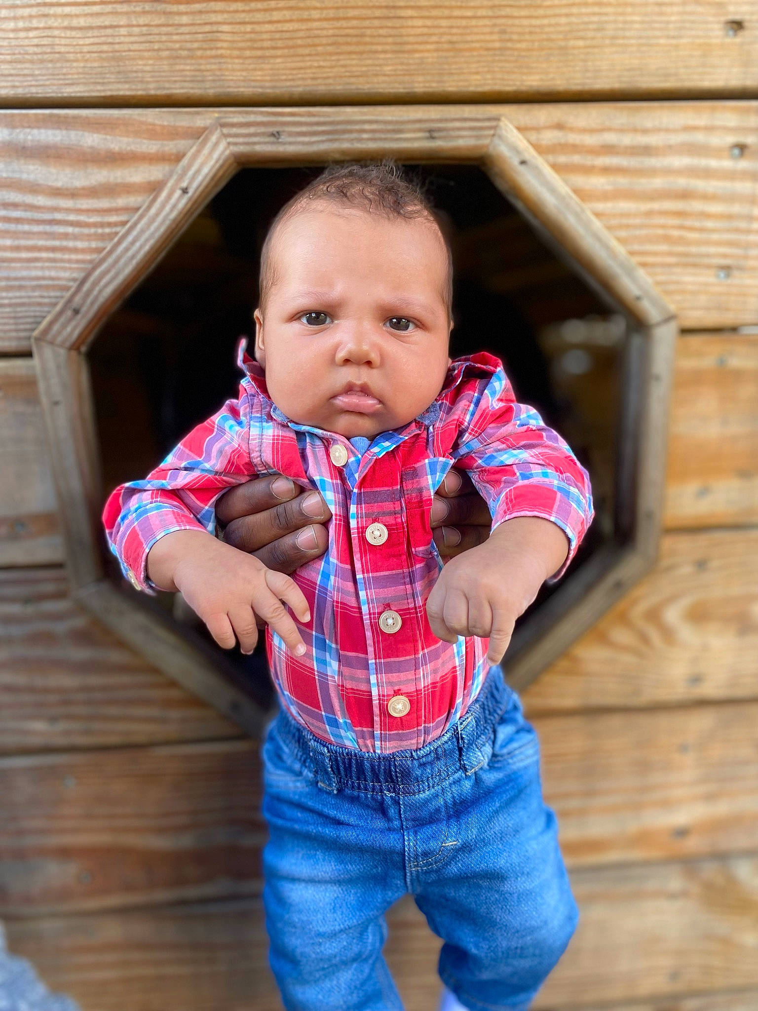Julius is registered to the contest to win money with this photo: baby, baby_toddler_clothing, collar, flooring, happy, human_body, jacket, jeans, leg, nose, orange, outerwear, pattern, person, plaid, skin, sleeve, standing, t_shirt, toddler
