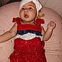 Luna is registered to the contest to win money with this photo: baby, infant, child, red_outfit, headband, white_bow, pink_cushion, expression, mouth_open, indoor, cute, soft_furniture, person, portrait, celebration, patterned_clothing, happy, small_child, lying_down, closeup