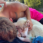 Aïko participe au concours pour gagner de l'argent avec cette photo : person, puppy, dog, sleeping, outdoor, nature, blanket, toy, relaxation, companion, tattoo, summer, riverbank, greenery, sunlight, casual, cuddle, rest, pet, closeup