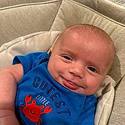 Dutton joined the competition — help win amazing prizes! baby, baby_clothes, blue_shirt, child, clothing, crab_design, cushion, cute, expression, face, happy, head, indoors, infant, person, portrait, seat, skin, smiling, young_child