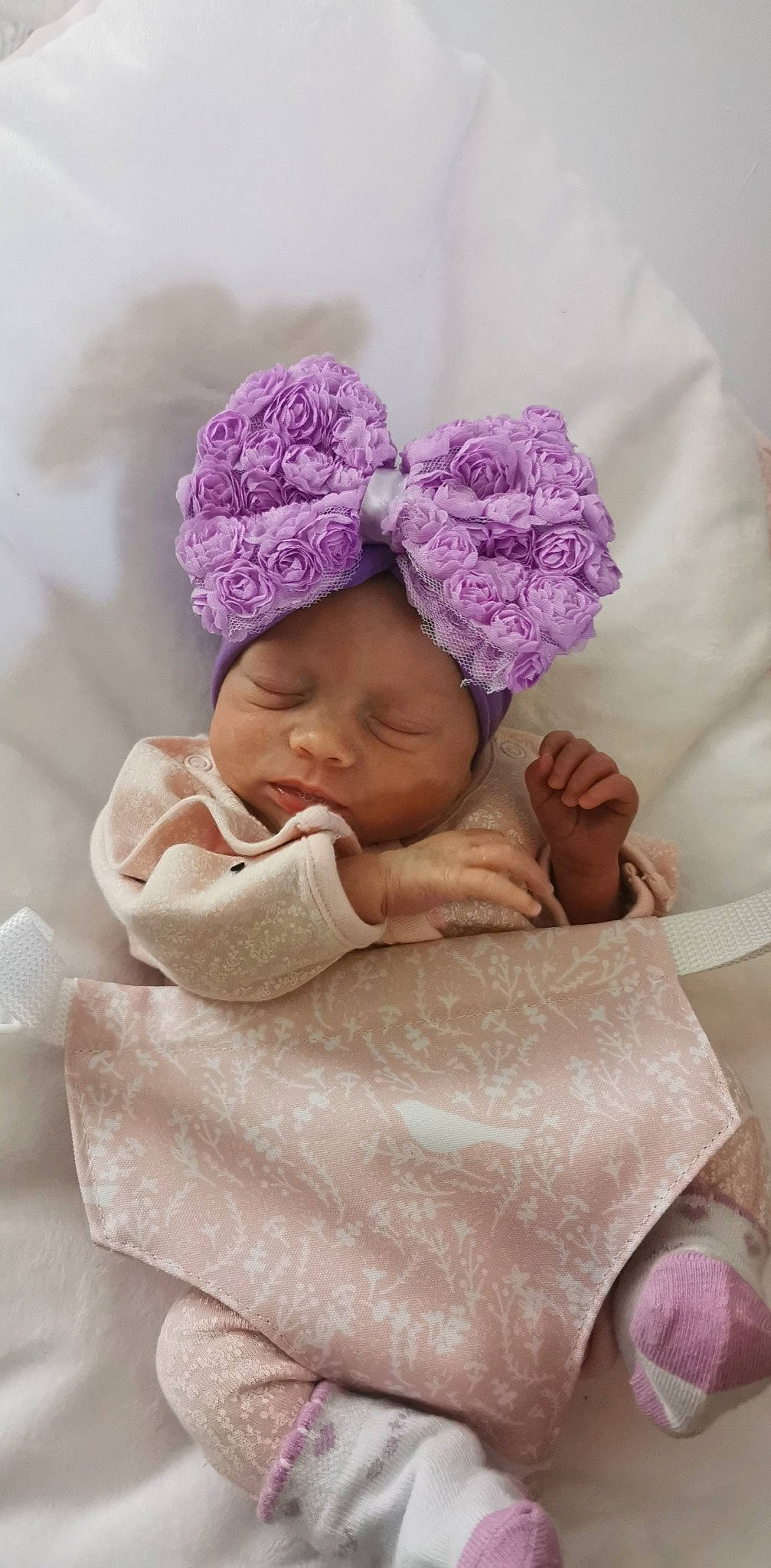 Kyra is registered to the contest to win money with this photo: baby, baby_sleeping, baby_toddler_clothing, beanie, cap, cheek, child, chin, comfort, fashion_accessory, hair_accessory, head, headwear, knit_cap, linens, magenta, person, pink, textile, toddler