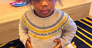 Siki Nelsia participe au concours pour gagner de l'argent avec cette photo : barefoot, carpet, child, cozy, curious, doll, furniture, hair, home, indoor, pants, person, play, portrait, rug, standing, sweater, toddler, toy, wood