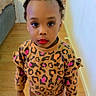 Siki Nelsia a rejoint le concours — aidez-le/la à gagner de superbes lots ! casual_clothing, child, colorful, expression, face, footwear, hair_braids, home, indoor, leopard_print, person, pink_pants, red_lipstick, standing, sweater, toddler, toy, walls, wooden_floor, young_child