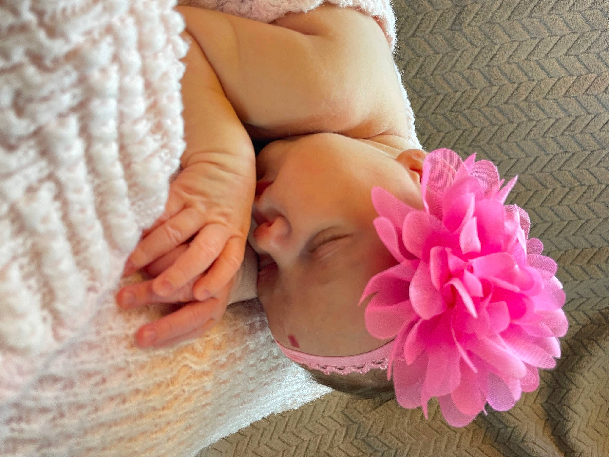 Kennedy is registered to the contest to win money with this photo: arm, child, comfort, cut_flowers, eyelash, finger, flower, gesture, hair_accessory, hand, headpiece, headwear, human_leg, magenta, nail, neck, peach, person, petal, pink