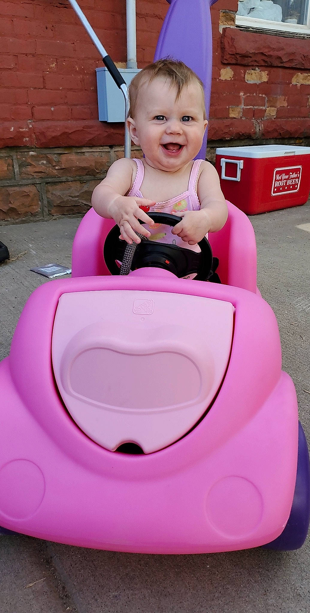 Lacey-mae is registered to the contest to win money with this photo: baby, child, fun, joy, leisure, person, pink, play, product, riding_toy, sitting, smile, toddler, toy, vacation