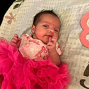 Ruby is registered to the contest to win money with this photo: baby, barbie_onesie, blanket, child, clothing, curious_expression, cute, face, hand, head, indoor, infant, lying_down, newborn, patterned_blanket, pink_tutu, portrait, resting, small_hands, soft_texture