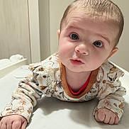 Lyv participe au concours pour gagner de l'argent avec cette photo : baby, infant, child, tummy_time, cute, face, eyes, clothing, patterned, soft_lighting, indoor, portrait, young, small_hands, curious, expression, skin, head, person, lying_down