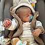 baby, sleeping, pacifier, knitted_sweater, hood, plush_toy, bunny, star_toy, baby_seat, cozy, child, infant, cute, soft_toys, relaxing, indoors, comfort, hand, face, clothing