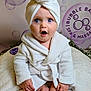 baby, child, blue_eyes, white_robe, towel_turban, surprised_expression, sitting, soft_blanket, spa_theme, bubbles, indoor, cute, portrait, infant, skin, hands, feet, comfort, relaxation, plush