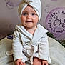 Theodore is registered to the contest to win money with this photo: baby, child, bathrobe, towel, toy, duck, smiling, blue_eyes, face, hands, feet, spa, bubbles, background, soft_texture, indoor, cute, person, happy, sitting
