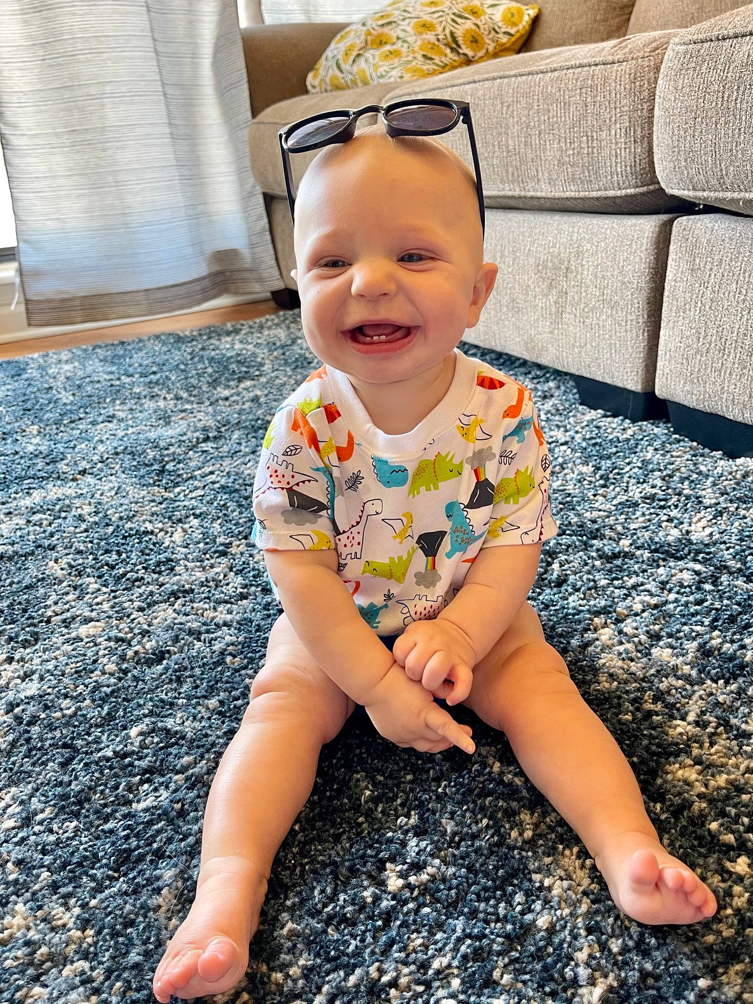 Mason joined the competition — help win amazing prizes! baby, baby_toddler_clothing, eye, face, floor, flooring, fun, grass, happy, human_leg, joy, light, pattern, person, sitting, skin, sleeve, smile, t_shirt, thigh